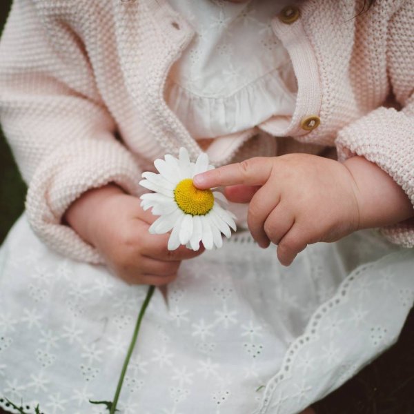 Ребенок с ромашкой в руках