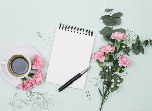Цветы и блокнот на столе