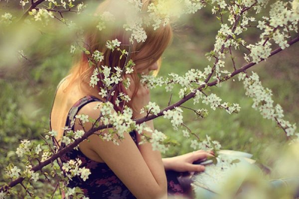 Девушка в саду со спины