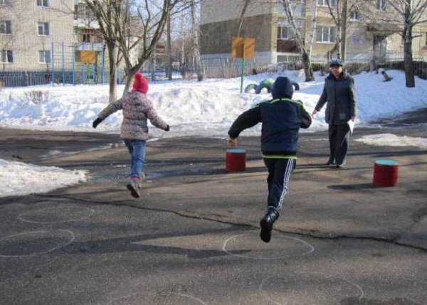 Дети играют в футбол на улице