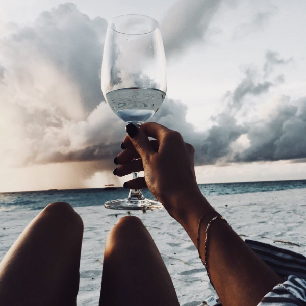 Девушка с бокалом на море