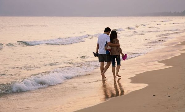 Мужчина и женщина идут по пляжу