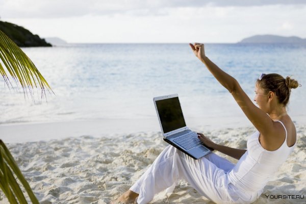 Девушка с ноутбуком на берегу океана