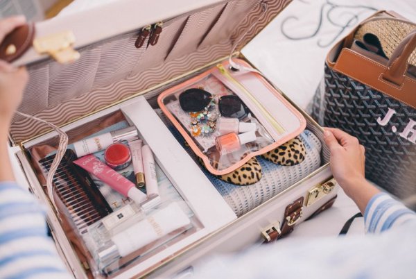 Женщина собирает чемодан