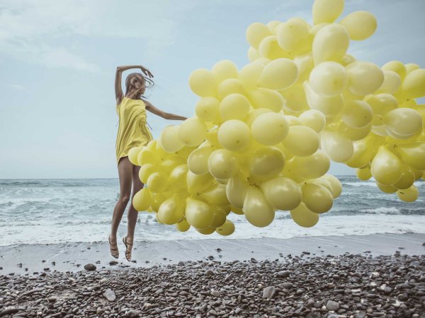 Девушка с шарами на море