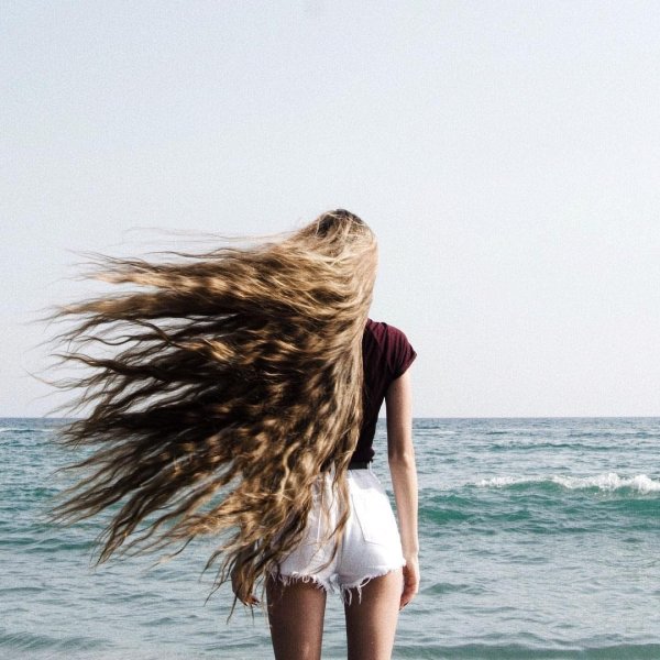 Девушка с длинными волосами у моря