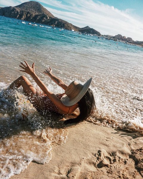 Человек идет по берегу моря