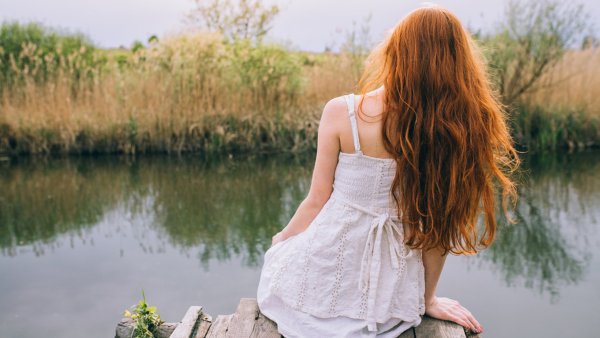 Девушка сидит на берегу моря