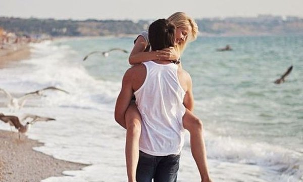 Пара со спины на берегу моря