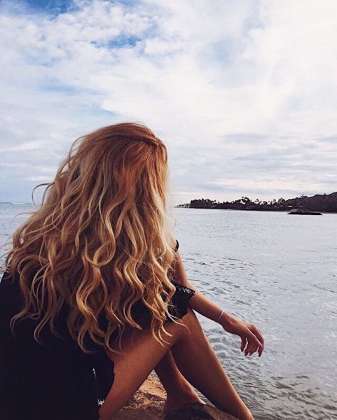 Блондинка с длинными волосами на море