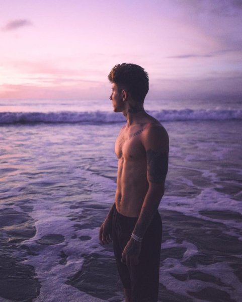 Мужчина на берегу моря с ноутбуком