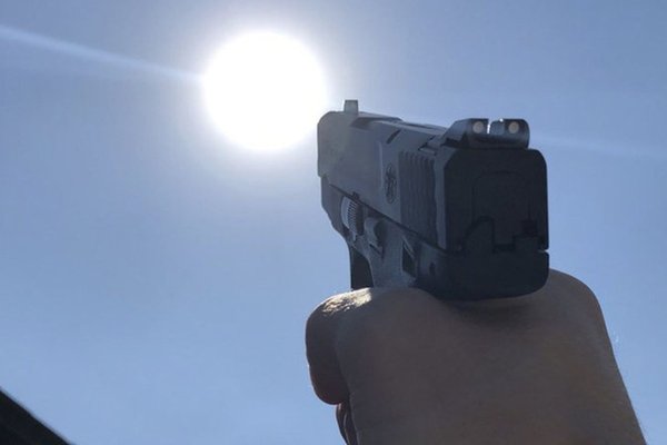 Пистолет направленный на солнце
