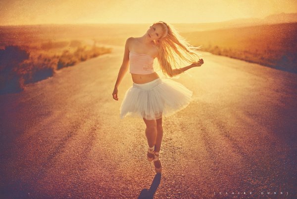 Девушка танцует в лучах солнца