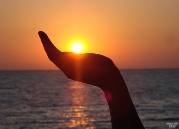 Девушка держит солнце