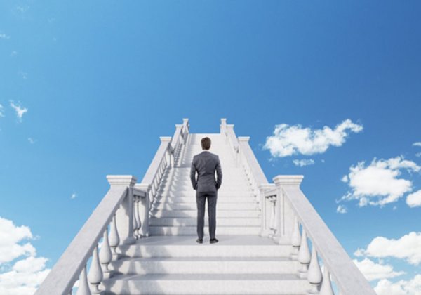 Человек поднимается по лестнице в небо