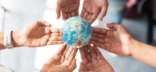 Docotor holding a World