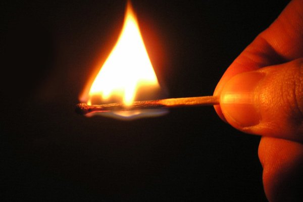 Горящая спичка в руке
