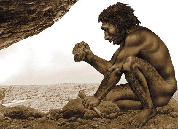 Доисторический человек с камнем