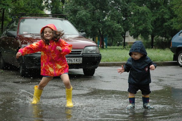 Дети бегают по лужам