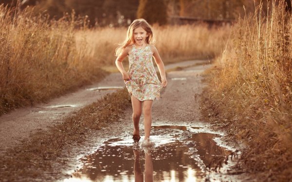 Девочка бегает по лужам