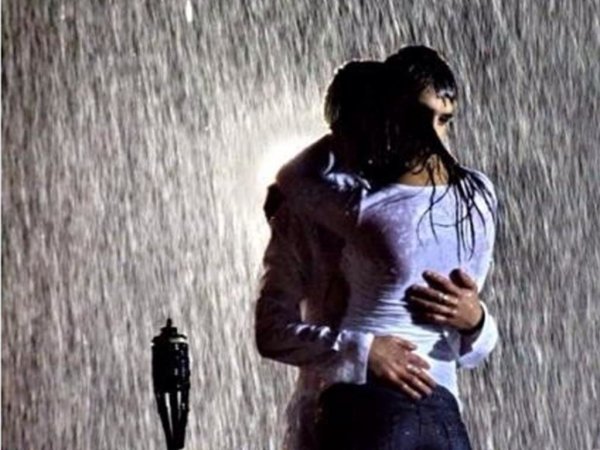 Парень и девушка обнимаются под дождем