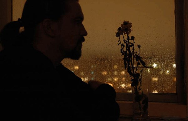 Мужчина вечером у окна