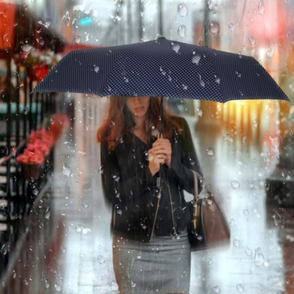 Женщина с зонтом под дождем