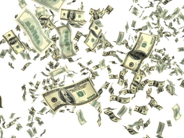Падающие деньги на белом фоне