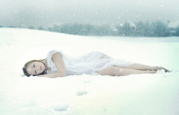 Девушка лежит на снегу