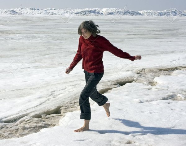 Девушка бежит по снегу босиком