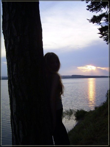 Девушка у реки со спины