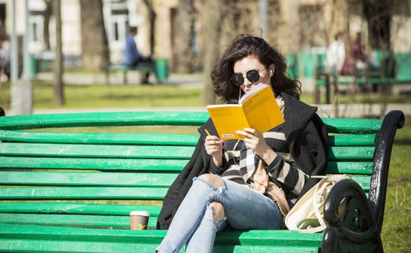 Девушка с книжкой на скамейке