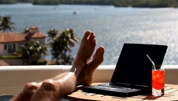 Мужчина с ноутбуком на пляже