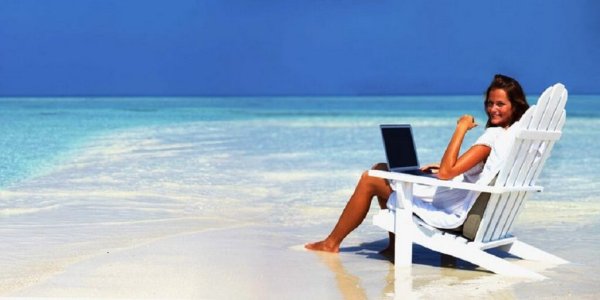 Девушка с ноутбуком на берегу океана