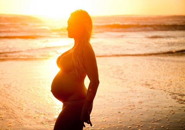 Беременная девушка на закате