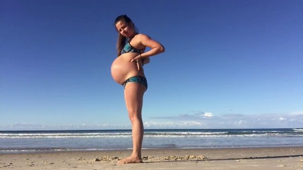 Беременная девушка на пляже