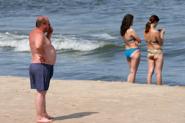 Полные мужчины на пляже